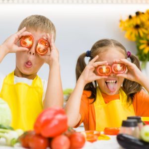 Kids having fun cooking health food together